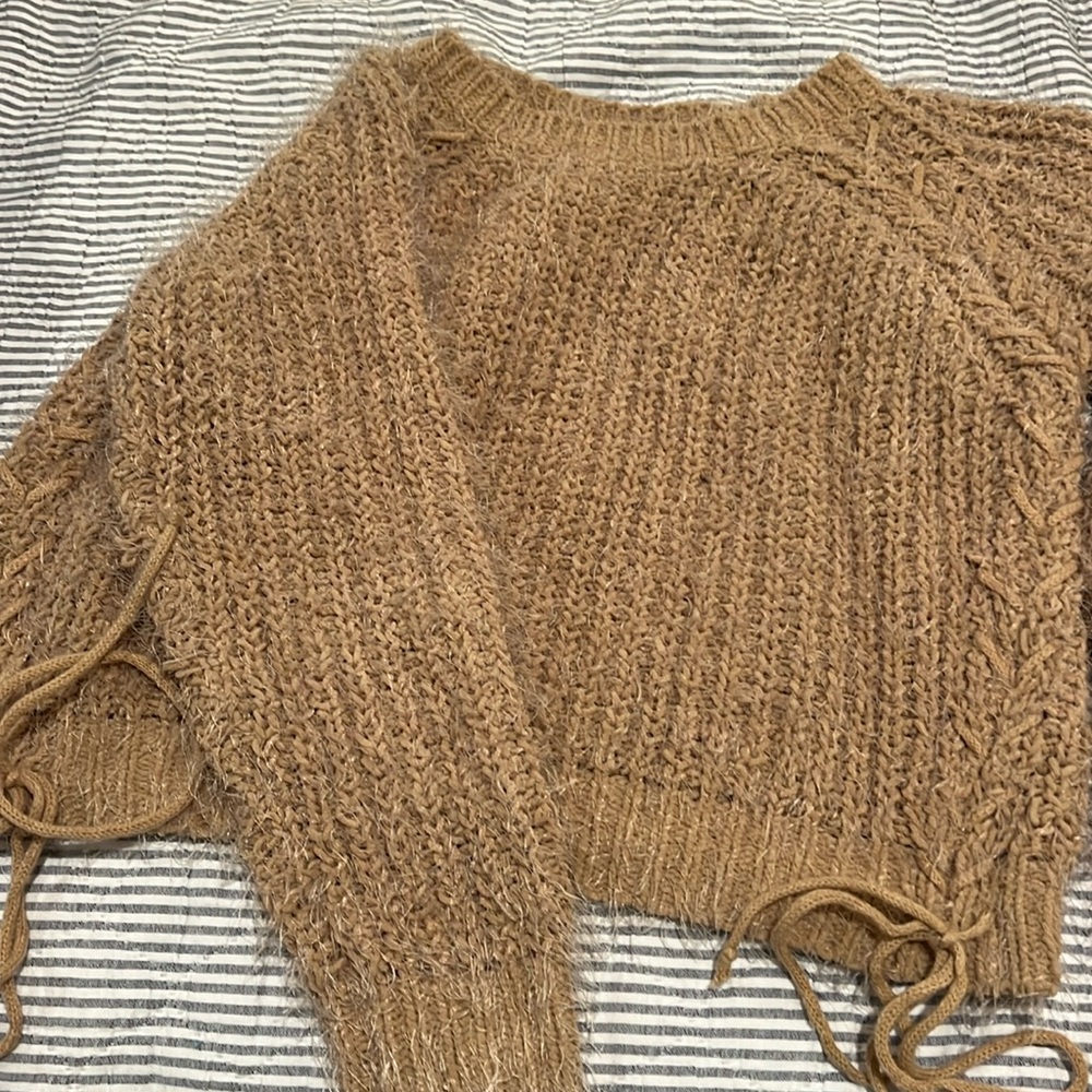 Woven heart medium sweater. It has a tie going down.